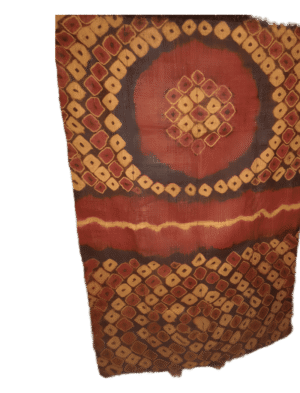 Tissu traditionnel africain avec motifs géométriques rouges, oranges et noirs.